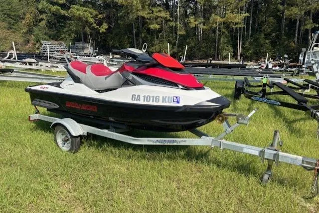 Slide: The Image of 2010 Sea-Doo GTX 155 jet ski on trailer, parked on grass. - 8