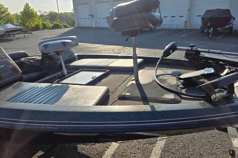 Slide: The Image of 1993 Boomeranger 482V boat interior with seats and equipment in a parking lot. - 3