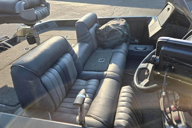 Slide: The Image of Interior of a 1993 Boomeranger 482V boat with leather seats and steering wheel. - 4
