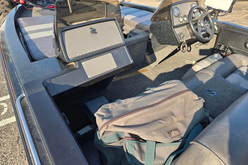 Slide: The Image of Interior of a 1993 Boomeranger 482V boat with steering wheel and storage bag. - 9