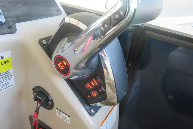 Slide: The Image of Control panel of 2023 Harris Sunliner 250 boat with start/stop button and throttle lever. - 7