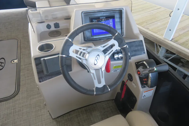 Slide: The Image of 2023 Harris Sunliner 250 helm with steering wheel, control panel, and navigation display. - 8