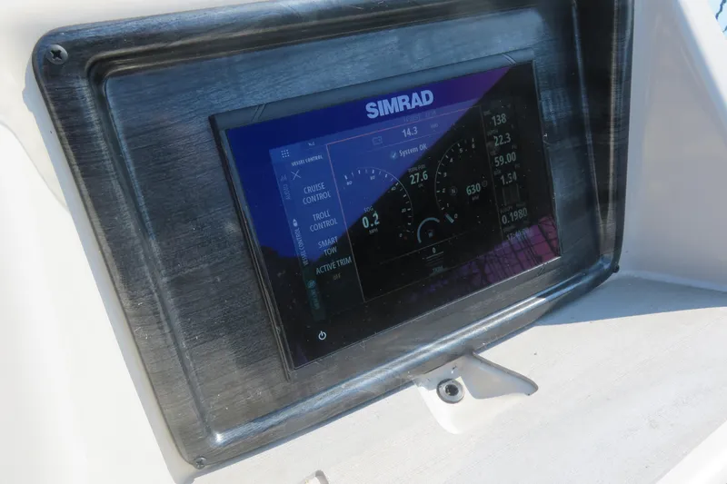 Slide: The Image of Simrad display on 2023 Harris Sunliner 250 boat dashboard, showing vessel control settings. - 9