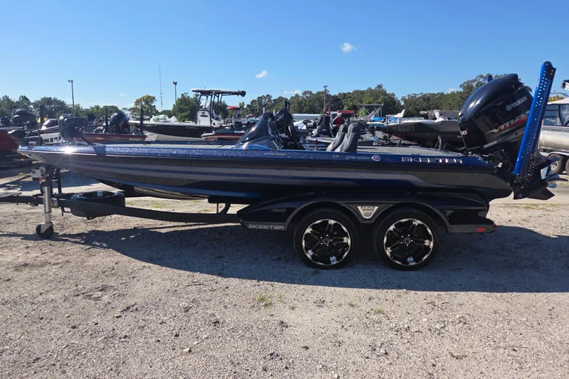 The Image of 2018 Skeeter FX20 bass boat with Yamaha engine on trailer in outdoor setting. - 0