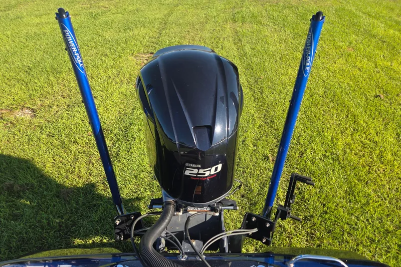 Slide: The Image of 2018 Skeeter FX20 with Yamaha 250 engine and Power-Pole anchors on grassy field. - 11