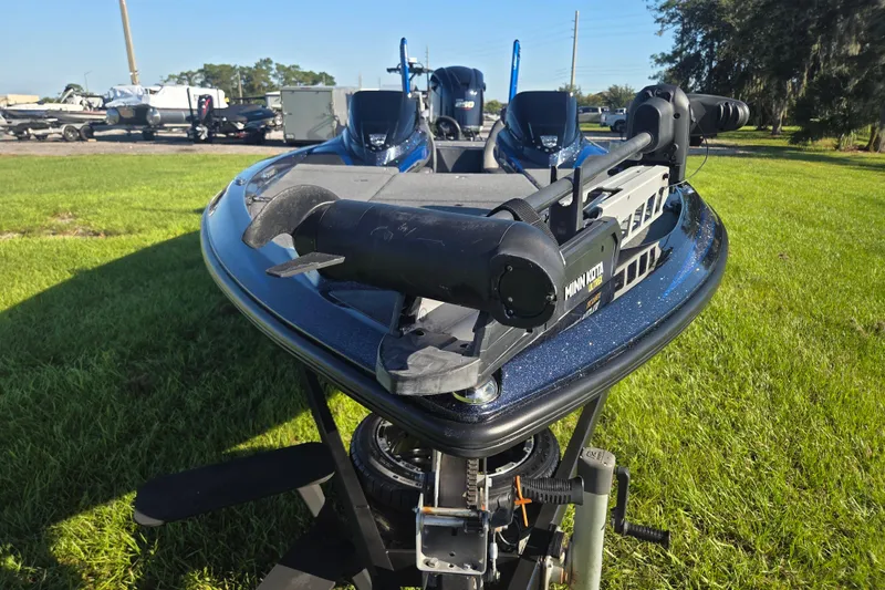 Slide: The Image of 2018 Skeeter FX20 bass boat with Minn Kota trolling motor on grassy area. - 4