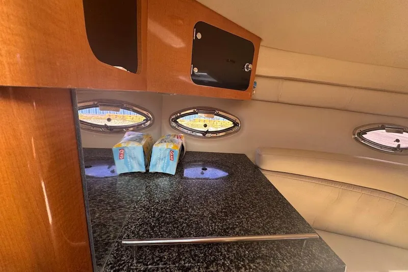 Slide: The Image of Interior of 2010 Chaparral 275 SSi boat with granite countertop and wooden cabinetry. - 12
