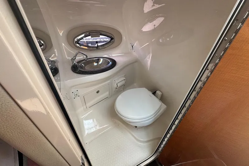 Slide: The Image of 2010 Chaparral 275 SSi boat bathroom with sink and toilet. - 13