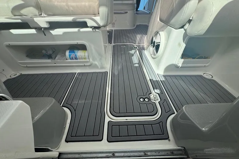 Slide: The Image of Interior of 2010 Chaparral 275 SSi boat with sleek flooring and storage compartments. - 14