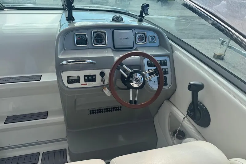 Slide: The Image of 2010 Chaparral 275 SSi boat dashboard with steering wheel and control panel. - 4