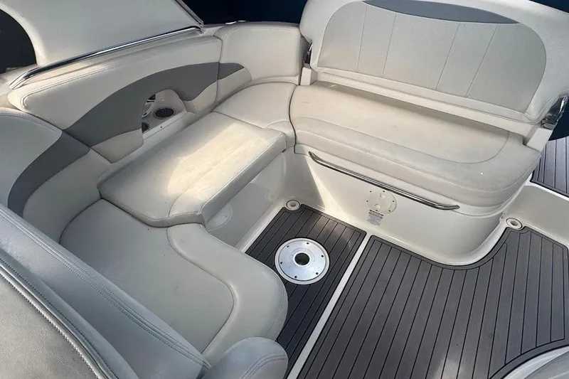 Slide: The Image of 2010 Chaparral 275 SSi boat interior with cushioned seating and sleek flooring. - 7