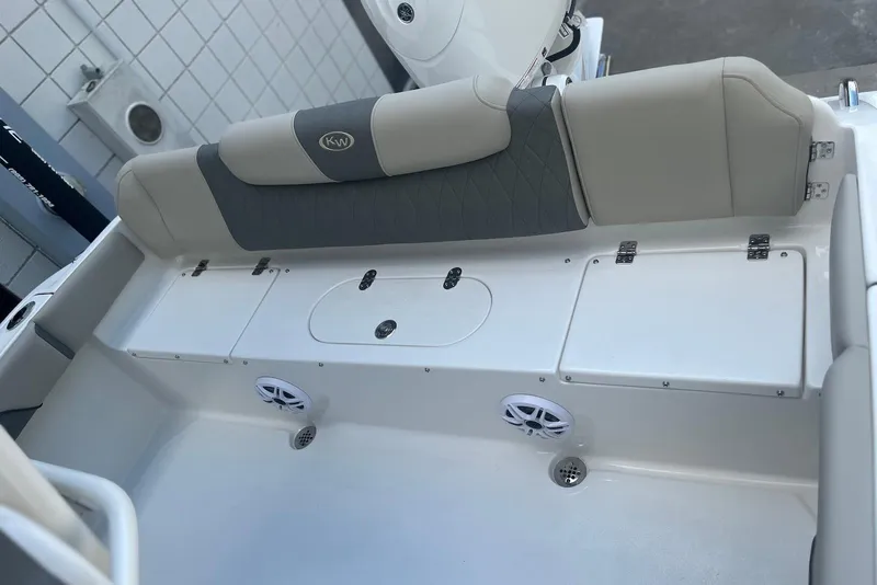 Slide: The Image of 2026 Key West 219 FS boat interior with cushioned seating and storage compartments. - 14