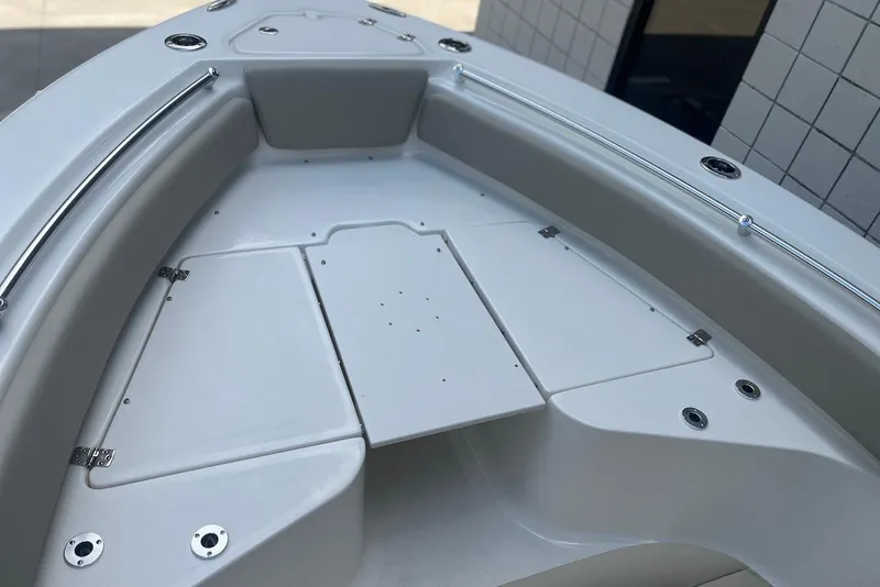 Slide: The Image of 2026 Key West 219 FS boat deck with storage compartments and stainless steel fittings. - 20