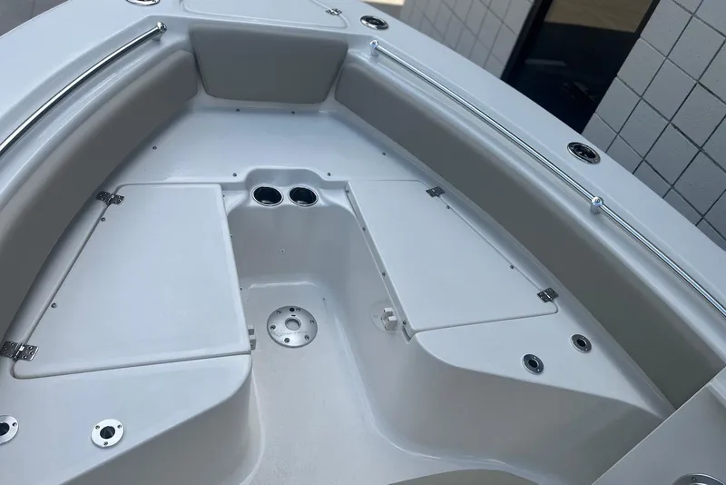 Slide: The Image of 2026 Key West 219 FS boat interior with storage compartments and cup holders. - 21