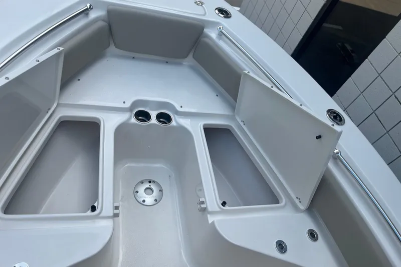 Slide: The Image of 2026 Key West 219 FS boat interior with open storage compartments and stainless steel fittings. - 22