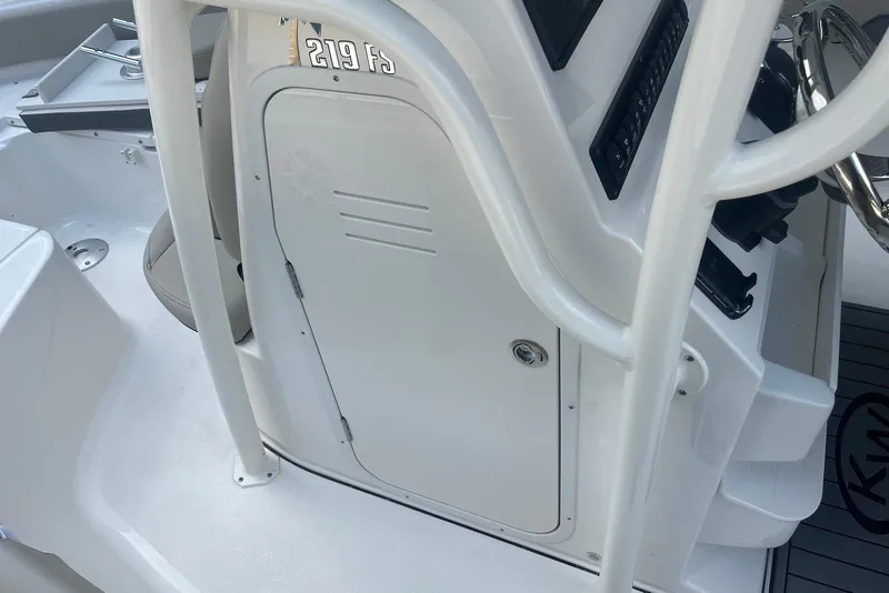 Slide: The Image of 2026 Key West 219 FS boat console with steering wheel and storage compartment. - 25