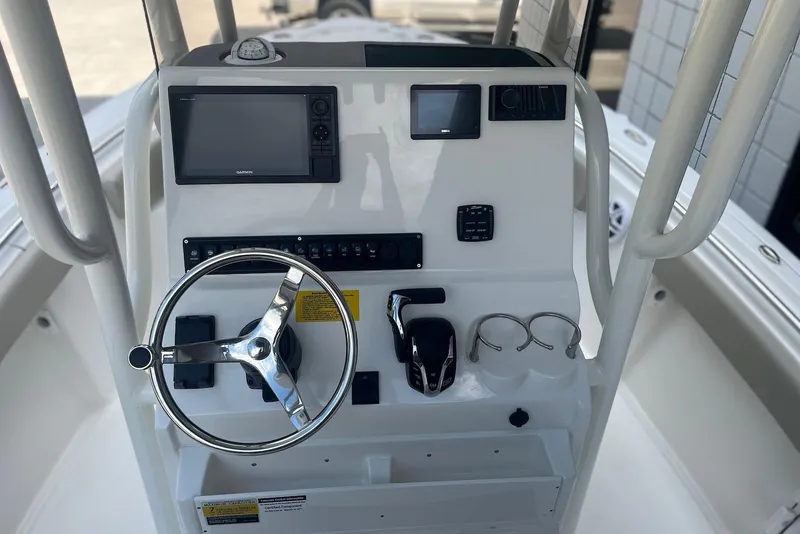 Slide: The Image of 2026 Key West 219 FS boat console with steering wheel and navigation controls. - 5