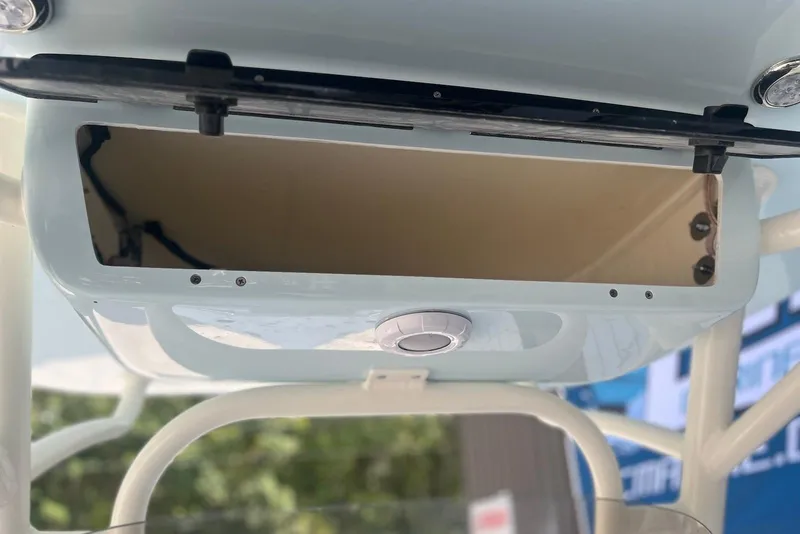 Slide: The Image of 2026 Key West 219 FS boat storage compartment with open lid and visible interior. - 9