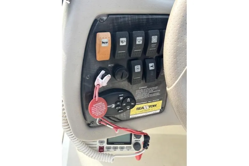 Slide: The Image of Control panel of a 2005 Stingray 220 DR boat with switches and safety key. - 11