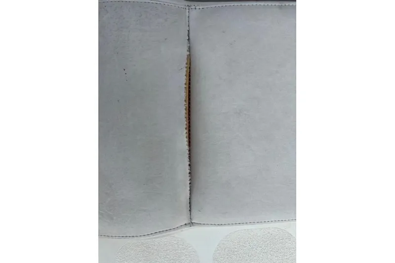 Slide: The Image of Close-up of a 2005 Stingray 220 DR boat seat with visible seam. - 15