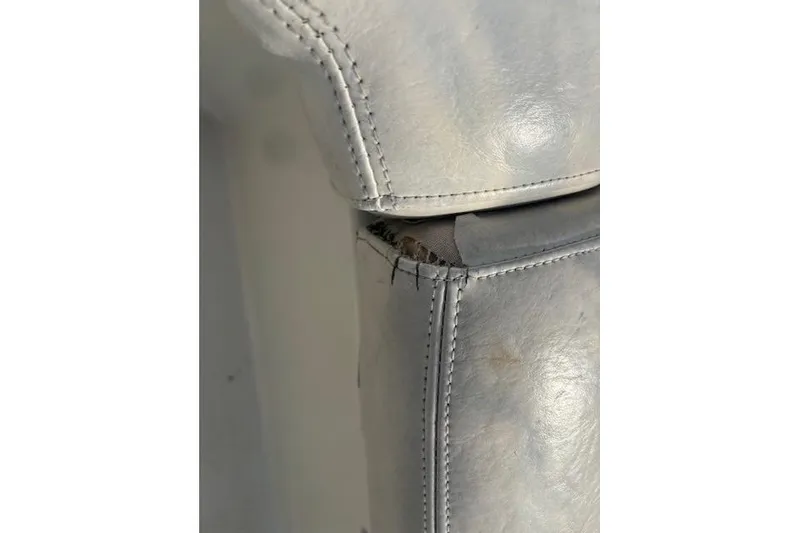 Slide: The Image of Torn upholstery on 2005 Stingray 220 DR boat seat, showing wear and stitching. - 16