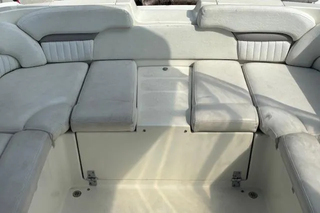 Slide: The Image of 2005 Stingray 220 DR boat interior with cushioned seating and storage area. - 5