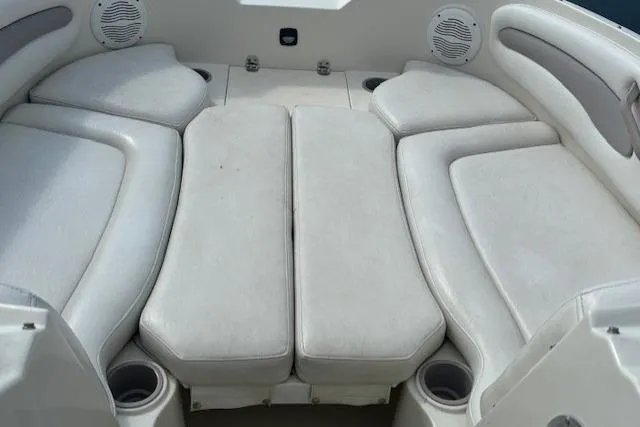 Slide: The Image of 2005 Stingray 220 DR boat interior with cushioned seating and cup holders. - 6