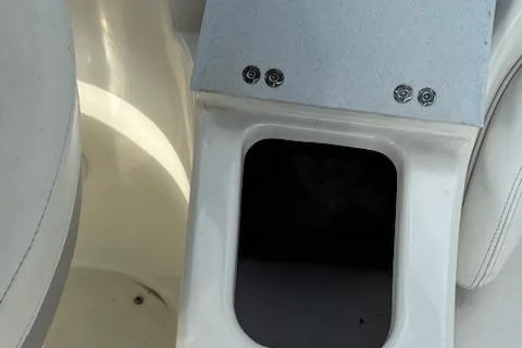 Slide: The Image of 2005 Stingray 220 DR boat interior with storage compartment and seating. - 7