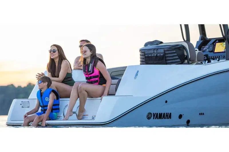 Slide: The Image of Family enjoying a day on a 2026 Yamaha 255 FSH Sport E boat. - 6