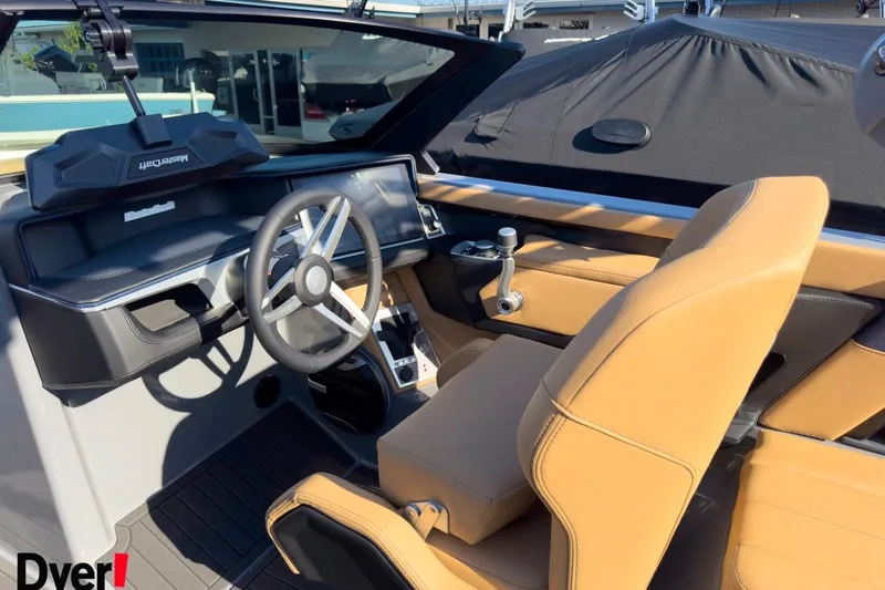 Slide: The Image of 2026 MasterCraft XT22 boat interior with tan seats and modern steering wheel. - 11