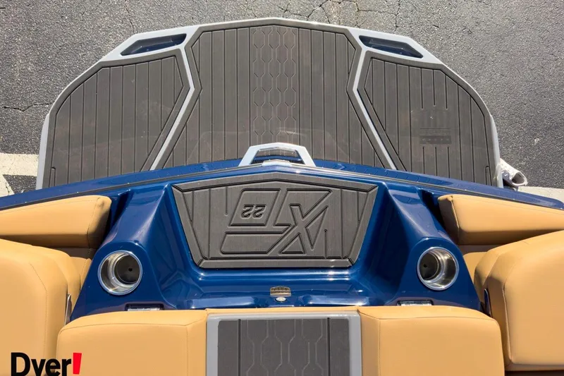 Slide: The Image of 2026 MasterCraft XT22 boat deck with blue and tan seating, featuring sleek design elements. - 14