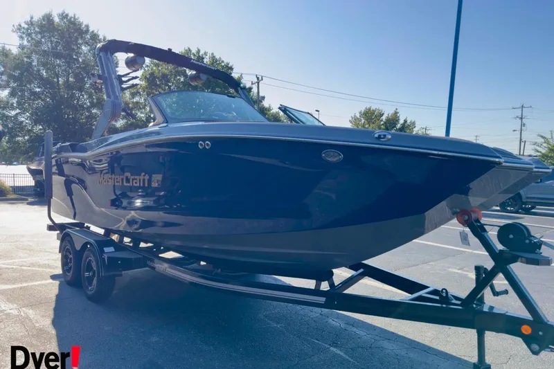 Slide: The Image of 2026 MasterCraft XT22 boat on trailer in parking lot, side view. - 5