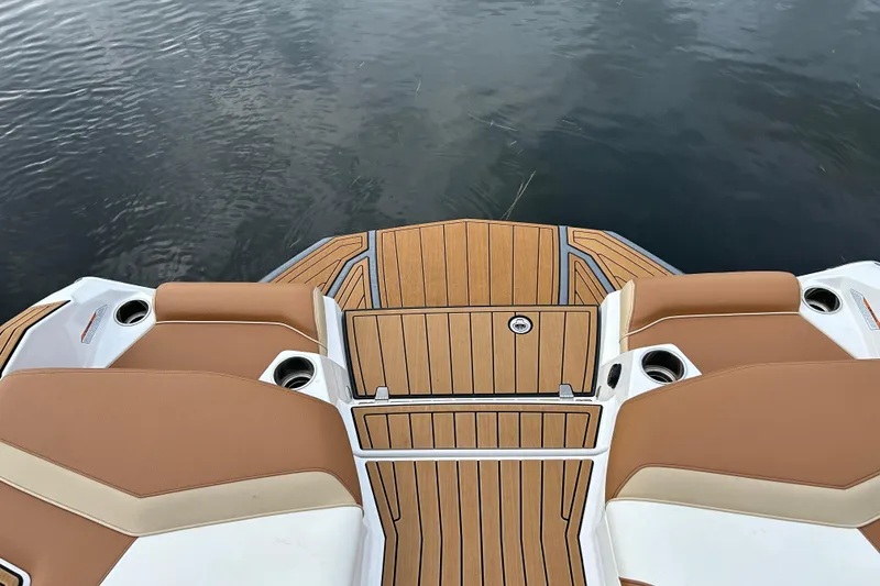 Slide: The Image of 2022 Nautique Super Air Nautique G21 boat deck with tan seating and wood finish. - 5