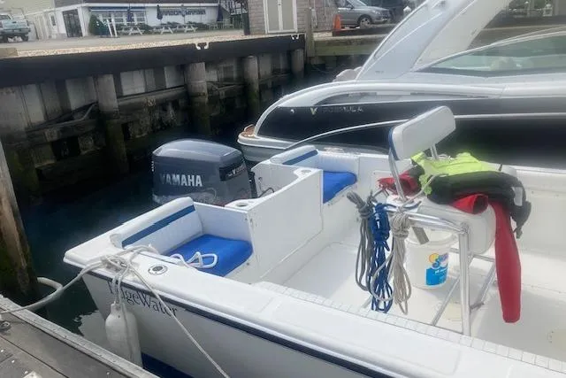 Slide: The Image of 1999 Edgewater 220CC boat docked with Yamaha outboard motor and safety gear. - 5