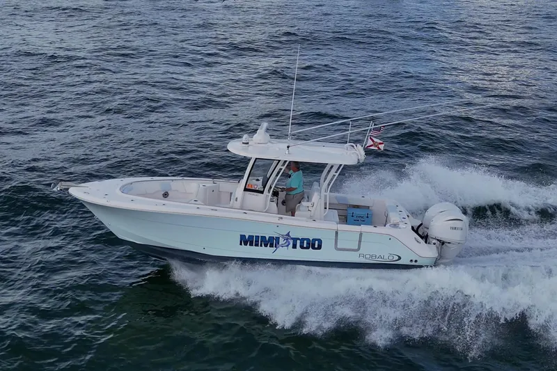 Slide: The Image of 2023 Robalo R302 Center Console boat cruising on open water. - 0