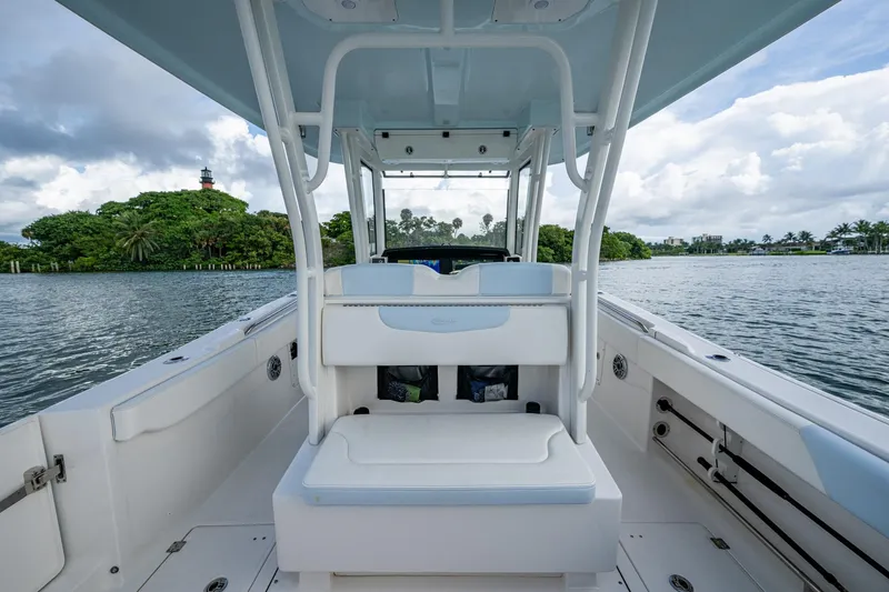 Slide: The Image of 2023 Robalo R302 Center Console boat on water, featuring spacious seating and scenic backdrop. - 11