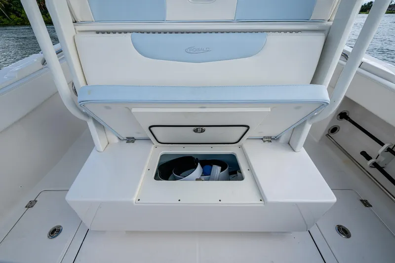 Slide: The Image of 2023 Robalo R302 Center Console boat storage compartment with open hatch, showcasing interior space. - 12