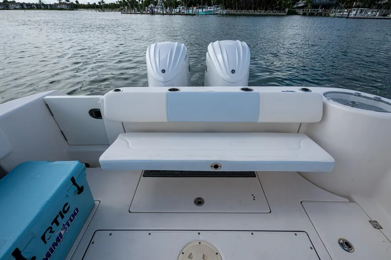 Slide: The Image of 2023 Robalo R302 Center Console boat with dual engines and seating area. - 14