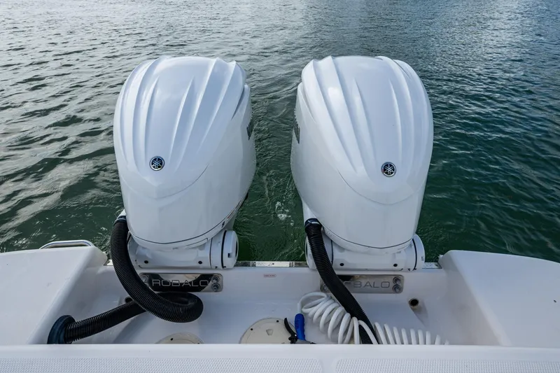 Slide: The Image of 2023 Robalo R302 Center Console with dual outboard engines on water. - 17