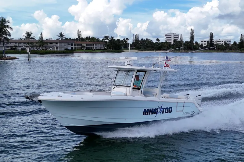 Slide: The Image of 2023 Robalo R302 Center Console boat cruising on a scenic waterway. - 19