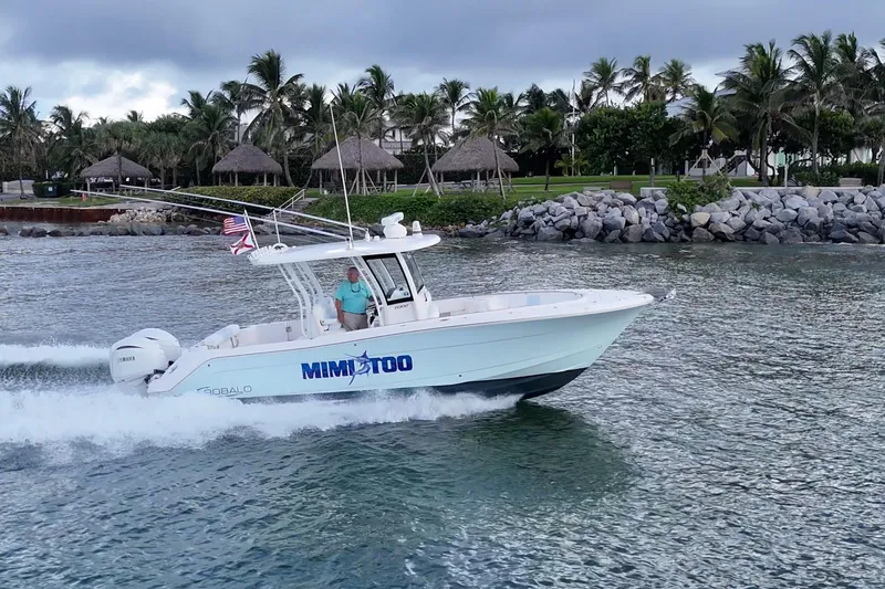 Slide: The Image of 2023 Robalo R302 Center Console boat cruising near a tropical shoreline. - 20