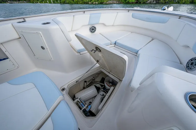 Slide: The Image of 2023 Robalo R302 Center Console boat interior with open storage compartment and cushioned seating. - 5