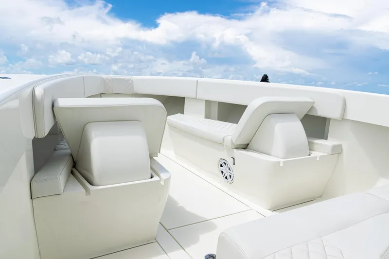 Slide: The Image of 2017 SeaVee 370z boat interior with white seating and clear blue sky. - 10