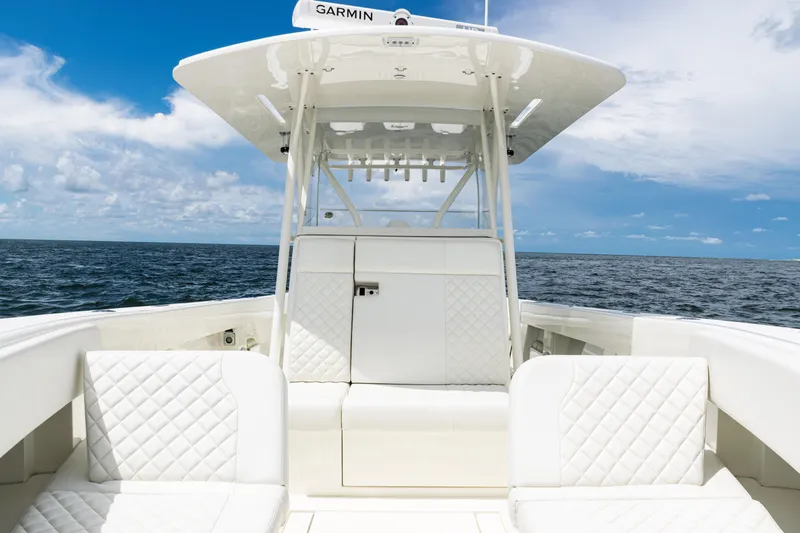 Slide: The Image of 2017 SeaVee 370z boat interior with white seating, ocean view, and blue sky. - 17