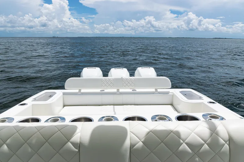 Slide: The Image of 2017 SeaVee 370z boat with white seating, ocean view, and cloudy sky. - 27