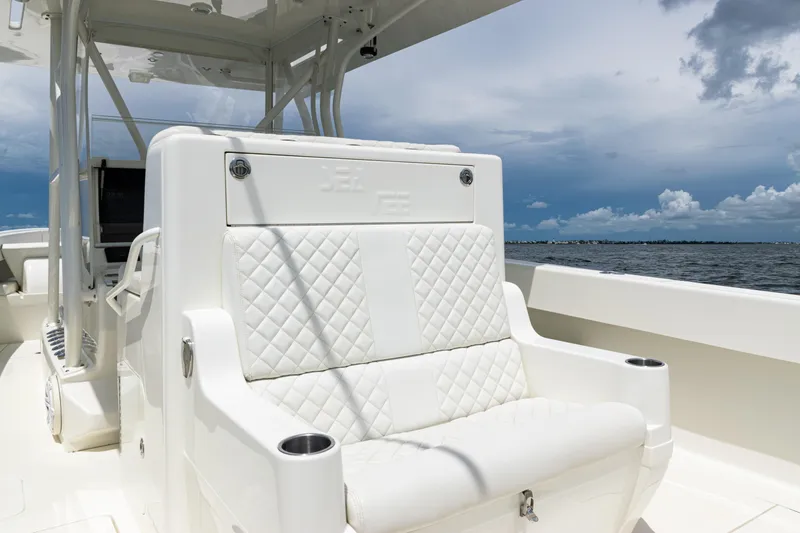 Slide: The Image of 2017 SeaVee 370z boat with white quilted seating, ocean view, and cloudy sky. - 32