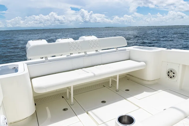 Slide: The Image of 2017 SeaVee 370z boat interior with white seating, ocean view, and clear sky. - 33