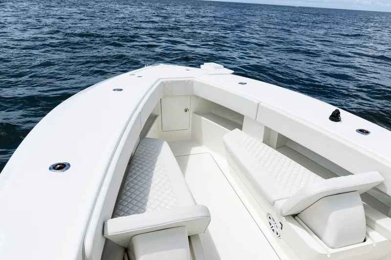 Slide: The Image of 2017 SeaVee 370z boat interior with white seating, on open water. - 5