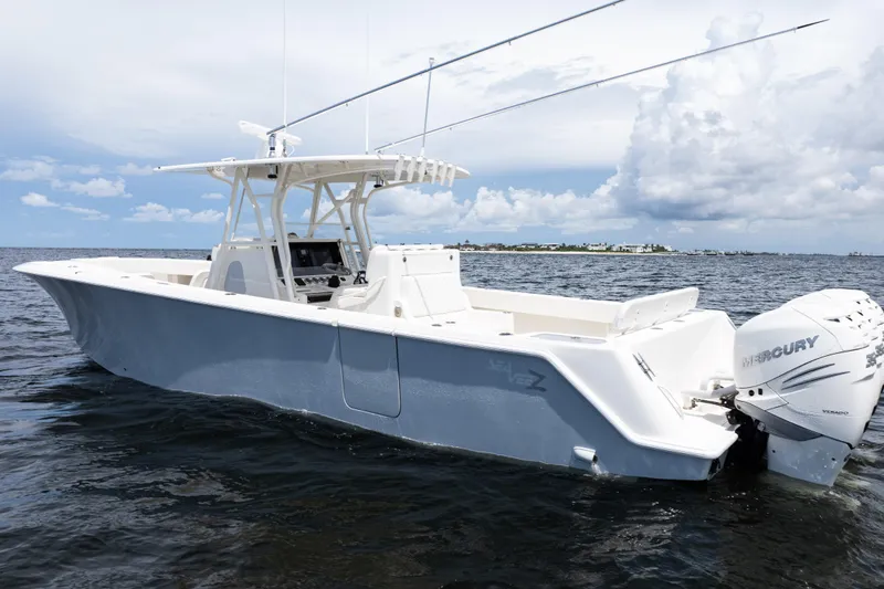 Slide: The Image of 2017 SeaVee 370z boat on water, featuring Mercury outboard engines, under a partly cloudy sky. - 53