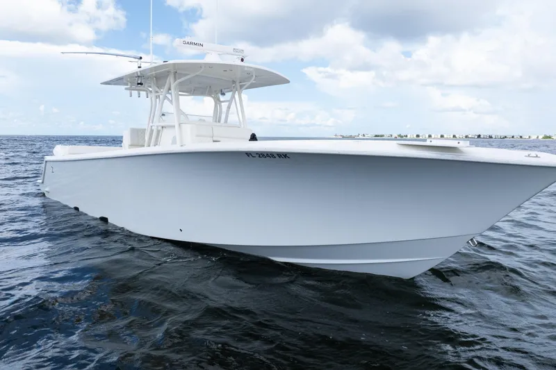 Slide: The Image of 2017 SeaVee 370z boat on open water under a cloudy sky. - 54